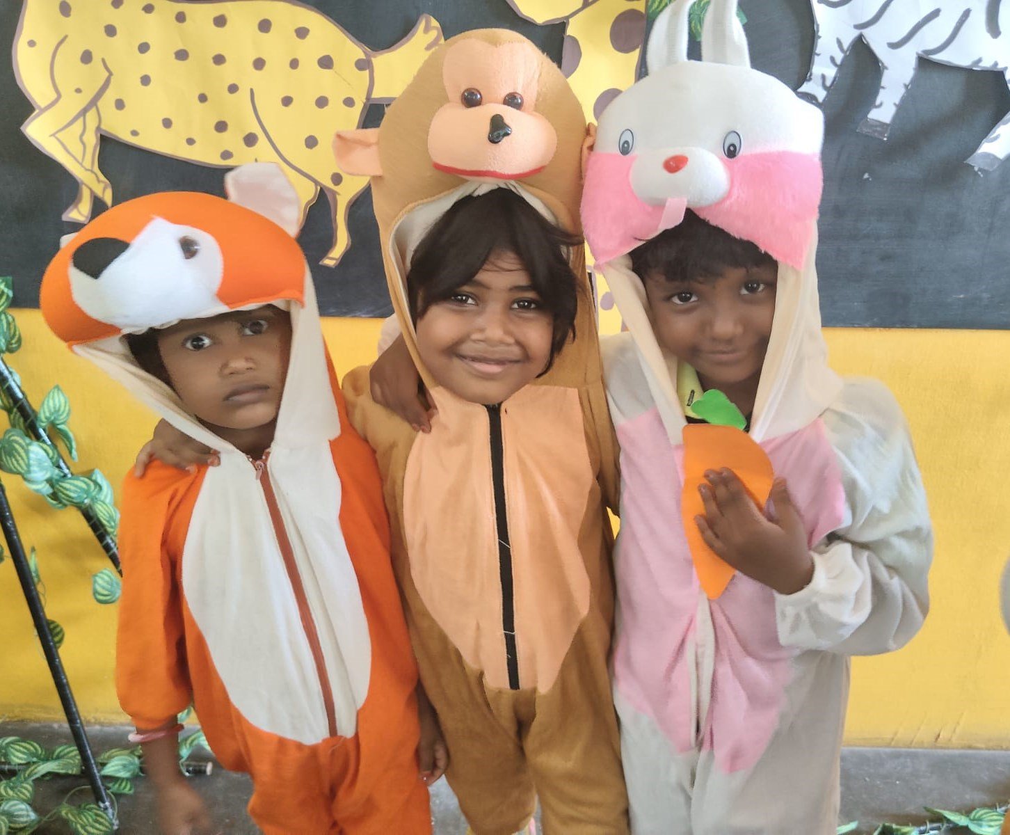 Three children in animal costumes