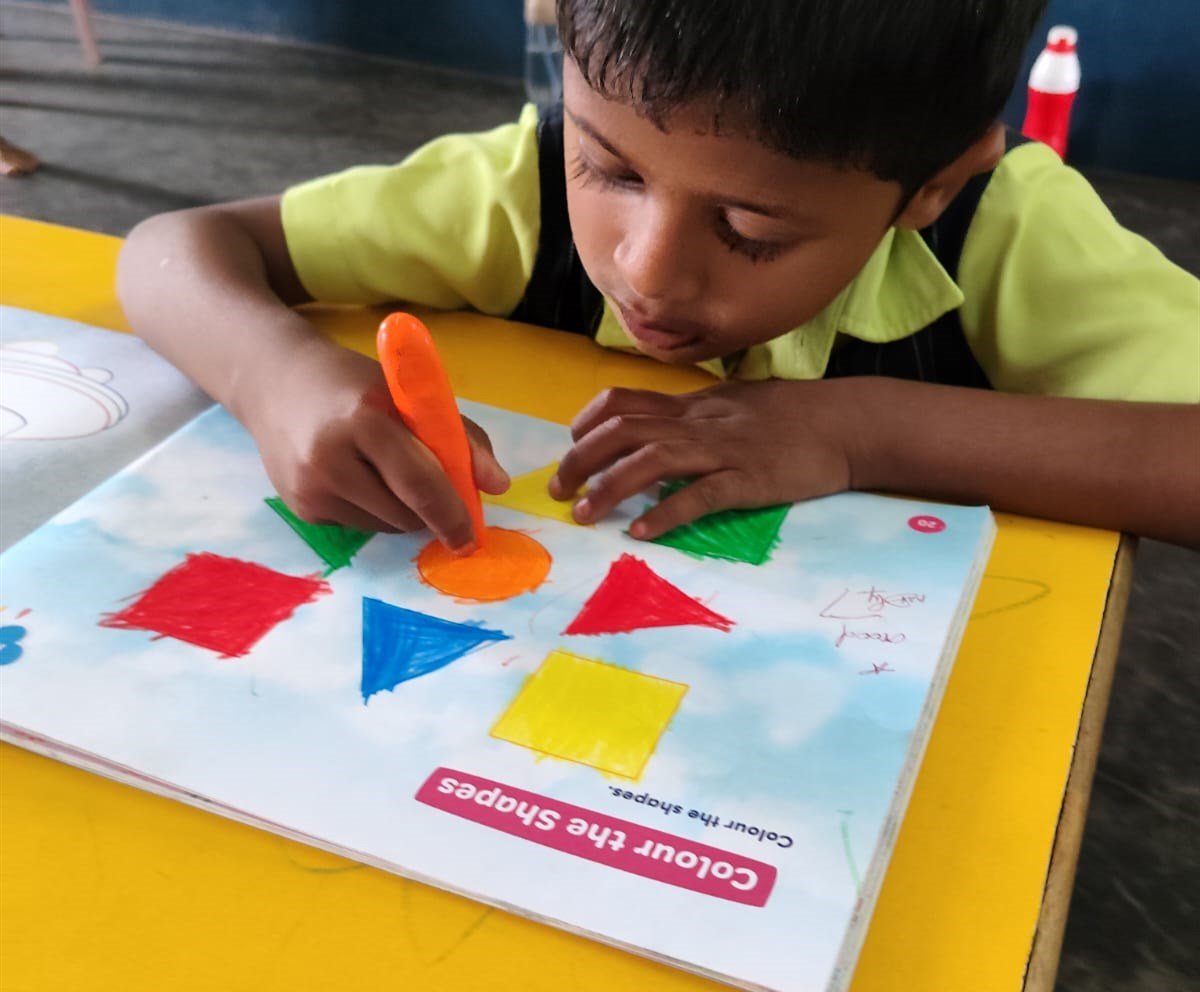 A child colouring shapes